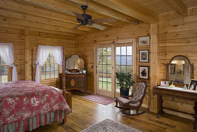 Interior, horizontal, master bedroom toward windows, Hofmann residence, Pike, New Hampshire, Coventry Log Homes